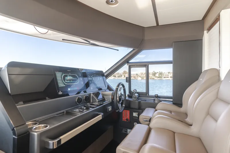 Slide: The Image of Interior helm of 2023 Azimut Magellano 66 yacht with modern controls and leather seating. - 37
