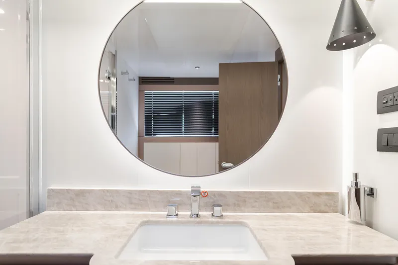 Slide: The Image of Modern bathroom vanity with round mirror in 2023 Azimut Magellano 66 yacht. - 48
