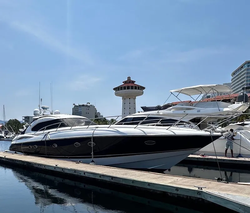 The Image of Sunseeker Predator 56 yacht docked at marina, clear sky, 2000 model. - 0