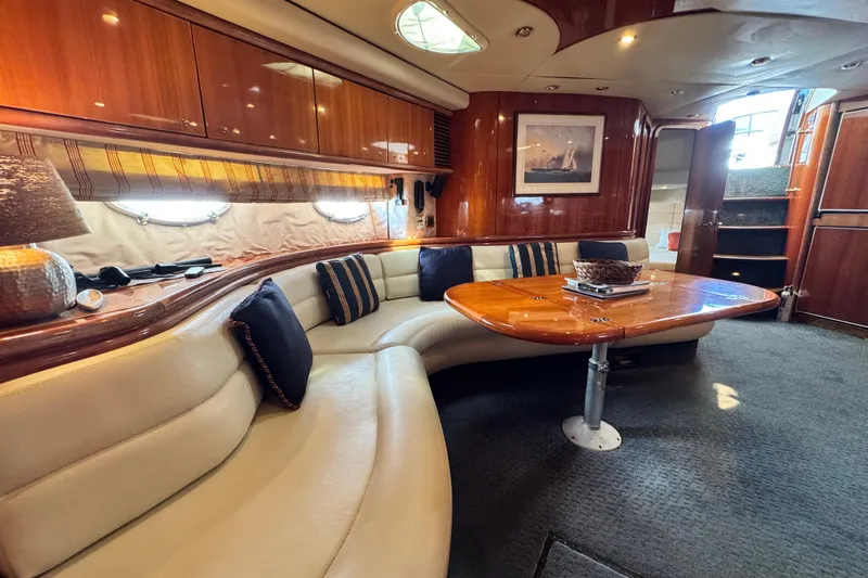 Slide: The Image of Luxurious interior of 2000 Sunseeker Predator 56 yacht with elegant seating and wooden table. - 16