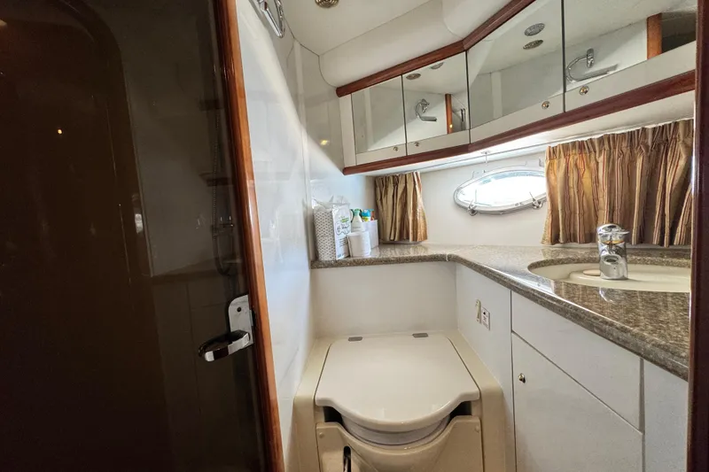 Slide: The Image of Luxurious bathroom in a 2000 Sunseeker Predator 56 yacht, featuring modern amenities. - 17