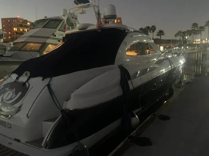 Slide: The Image of Sunseeker Predator 56 yacht docked at marina, clear sky, 2000 model. - 2