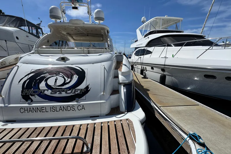Slide: The Image of Sunseeker Predator 56 yacht docked at Channel Islands, CA, with "Hot Stuff" branding. - 20