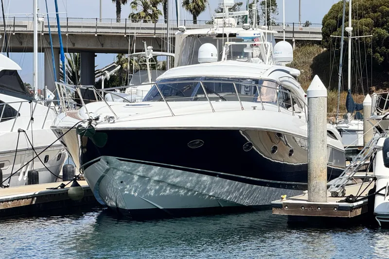 Slide: The Image of Sunseeker Predator 56 yacht docked at marina, showcasing sleek design and luxury features. - 21