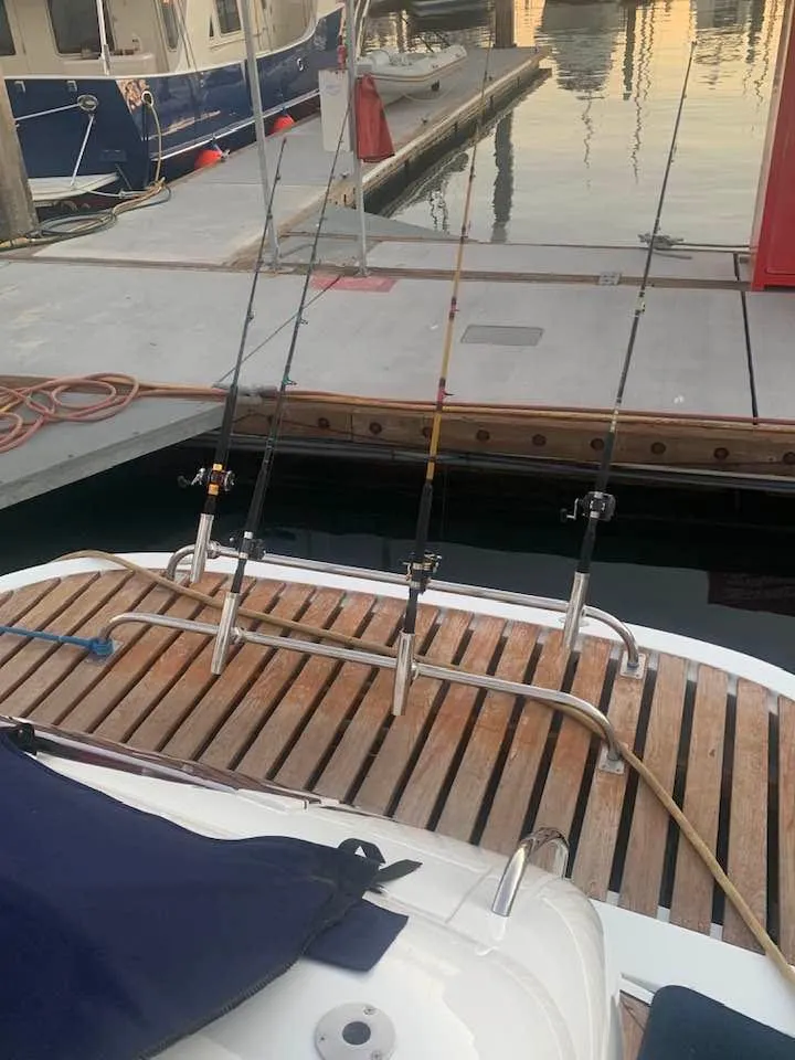 Slide: The Image of Sunseeker Predator 56 yacht deck with cushioned seating, 2000 model, docked at marina. - 4