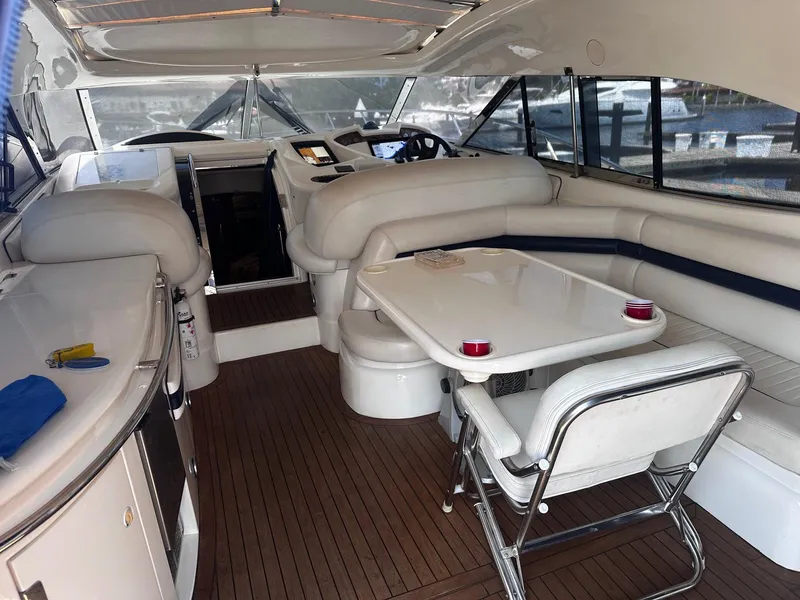 Slide: The Image of Interior of 2000 Sunseeker Predator 56 yacht with sleek white seating and modern amenities. - 5