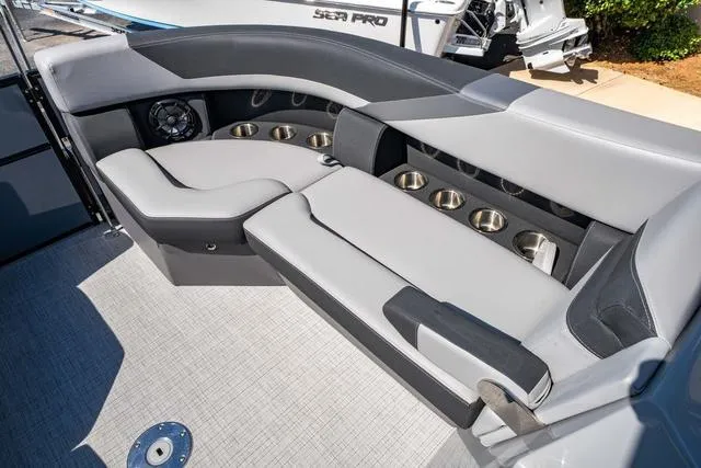 Slide: The Image of 2024 South Bay S224 UL 3.0 boat interior with gray seating and multiple cup holders. - 13