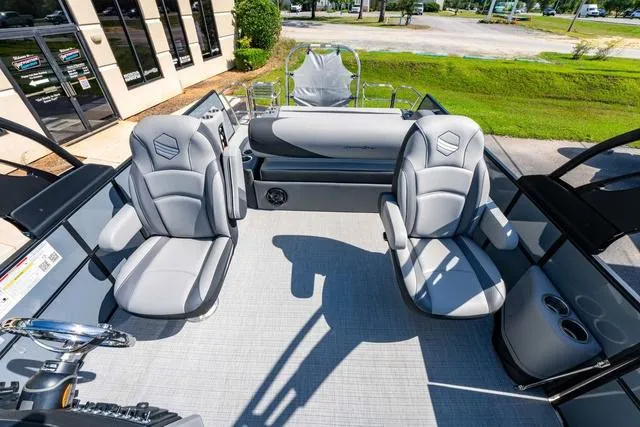 Slide: The Image of 2024 South Bay S224 UL 3.0 pontoon boat interior with gray seating and helm. - 16