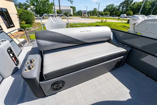 Slide: The Image of 2024 South Bay S224 UL 3.0 boat interior with gray seating and cup holders. - 17