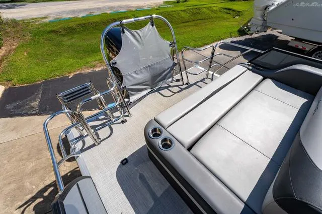 Slide: The Image of 2024 South Bay S224 UL 3.0 pontoon boat with sleek seating and cup holders. - 18