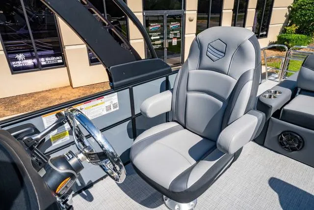 Slide: The Image of 2024 South Bay S224 UL 3.0 boat interior with captain's chair and steering wheel. - 23