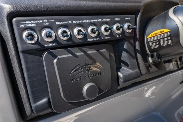 Slide: The Image of Control panel of 2024 South Bay S224 UL 3.0 boat with various switches and Wet Sounds audio. - 25