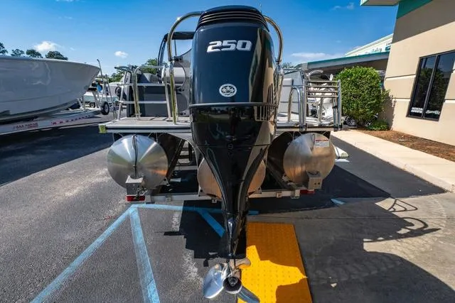 Slide: The Image of 2024 South Bay S224 UL 3.0 pontoon boat with powerful 250 HP engine, parked outdoors. - 4