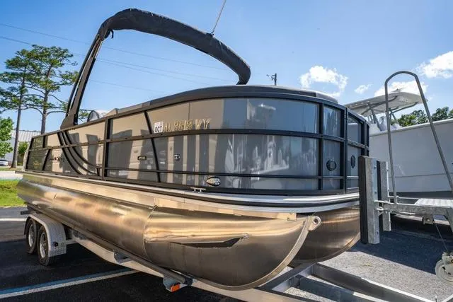 Slide: The Image of 2024 South Bay S224 UL 3.0 pontoon boat on trailer, outdoor display. - 7
