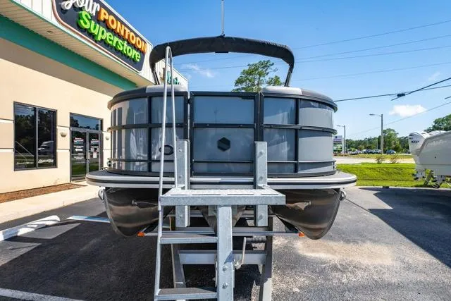 Slide: The Image of 2024 South Bay S224 UL 3.0 pontoon boat displayed at a dealership. - 8