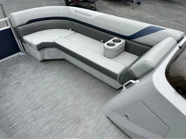 Slide: The Image of 2022 Bennington 22 SXFAPG boat interior with gray seating and cup holders. - 10