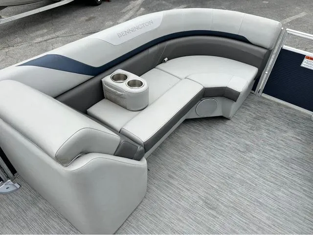 Slide: The Image of 2022 Bennington 22 SXFAPG boat interior with gray seating and cup holders. - 11