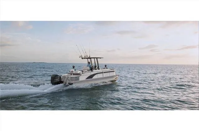 Slide: The Image of 2022 Bennington 22 SXFAPG fishing boat cruising on open water at sunset. - 19