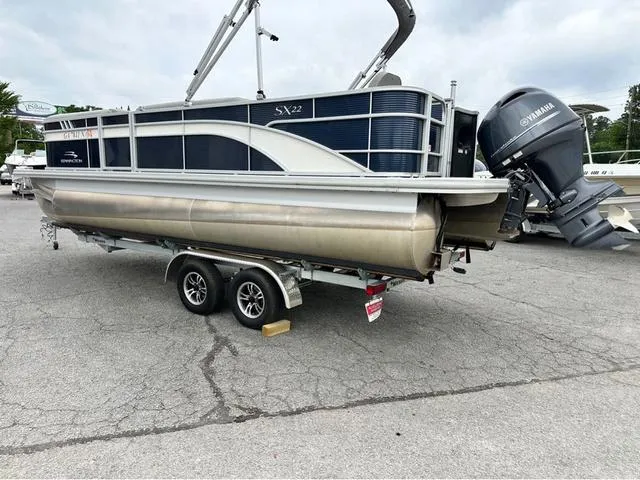 Slide: The Image of 2022 Bennington 22 SXFAPG pontoon boat with Yamaha outboard motor on trailer. - 2
