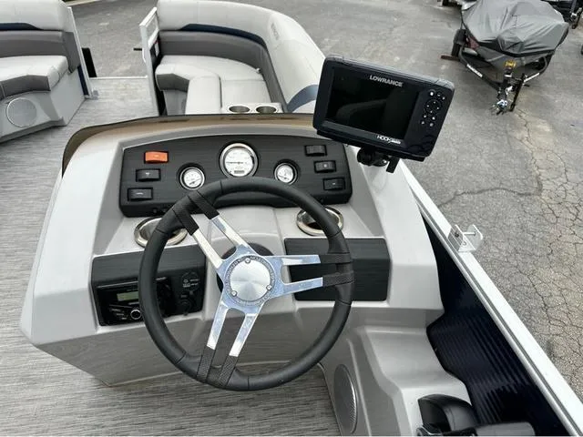 Slide: The Image of 2022 Bennington 22 SXFAPG boat dashboard with steering wheel and Lowrance fish finder. - 6