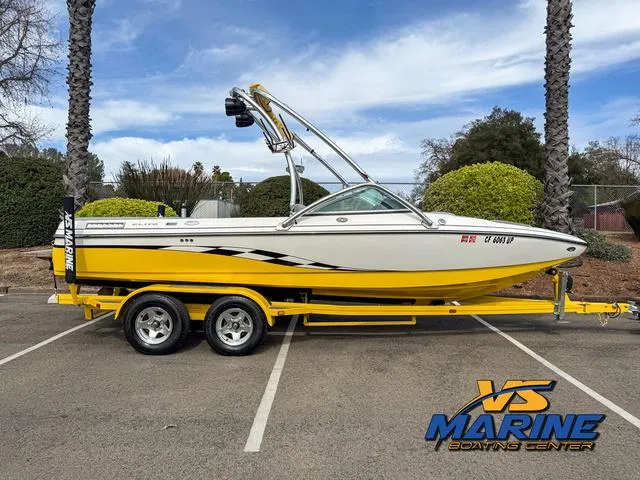 Slide: The Image of 2006 Centurion ELITE V boat in yellow and white, parked at VS Marine Boating Center. - 1