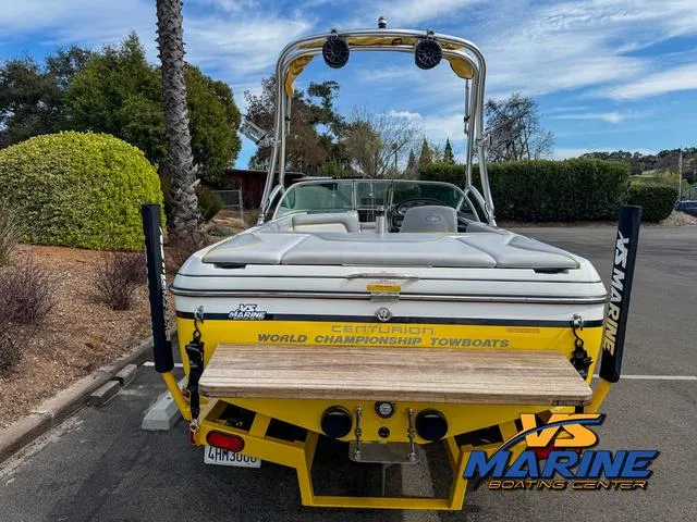 Slide: The Image of 2006 Centurion ELITE V boat, yellow, parked outdoors at VS Marine Boating Center. - 6