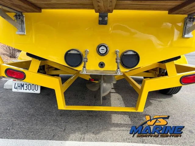 Slide: The Image of Rear view of a 2006 Centurion ELITE V boat with yellow hull and visible propeller. - 7