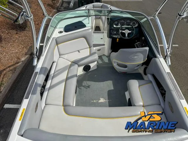 Slide: The Image of 2006 Centurion ELITE V boat interior with gray seating and steering console. - 9
