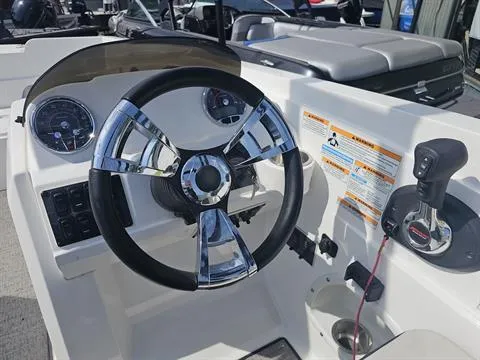 Slide: The Image of 2022 Hurricane SunDeck Sport 205 IO boat dashboard with steering wheel and controls. - 16