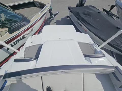 Slide: The Image of 2022 Hurricane SunDeck Sport 205 IO boat, docked alongside Alumacraft boats. - 17
