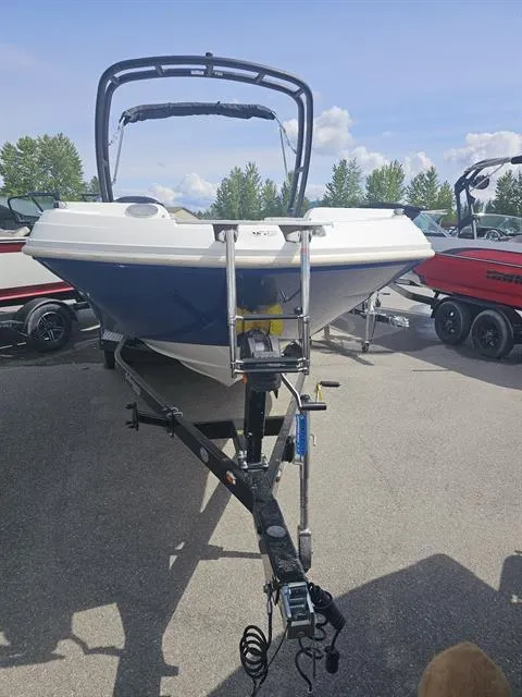 Slide: The Image of 2022 Hurricane SunDeck Sport 205 IO boat on trailer, parked outdoors. - 22