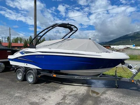 Slide: The Image of 2022 Hurricane SunDeck Sport 205 IO boat on trailer, blue and white, covered, outdoors. - 3