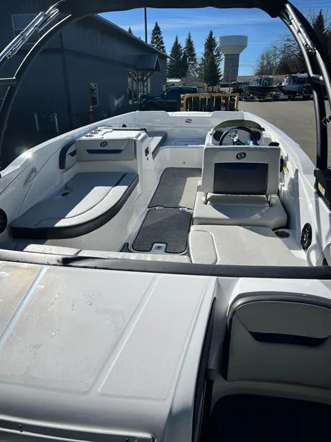 Slide: The Image of 2022 Hurricane SunDeck Sport 205 IO boat interior with seating and steering wheel. - 7