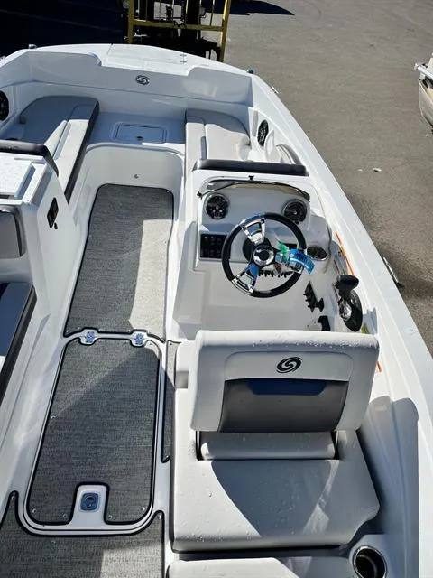 Slide: The Image of 2022 Hurricane SunDeck Sport 205 IO boat interior with steering wheel and seating. - 9