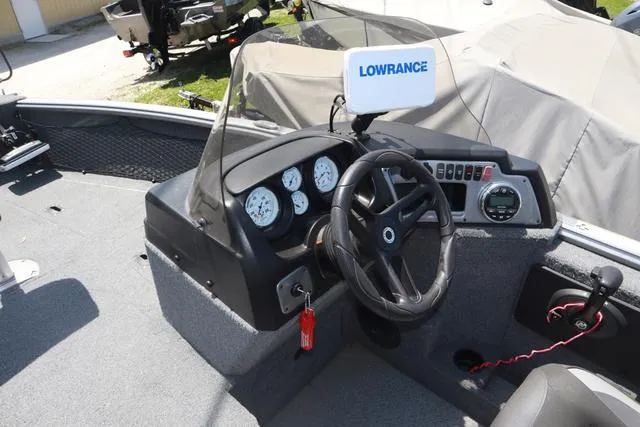 Slide: The Image of 2018 Lund 1875 Impact SC boat dashboard with steering wheel and Lowrance navigation system. - 13