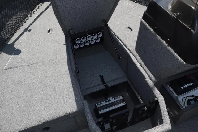 Slide: The Image of 2018 Lund 1875 Impact SC boat interior storage compartment with rod holders and battery. - 18