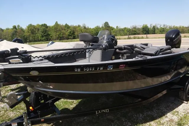 Slide: The Image of 2018 Lund 1875 Impact SC boat on trailer, parked outdoors. - 3