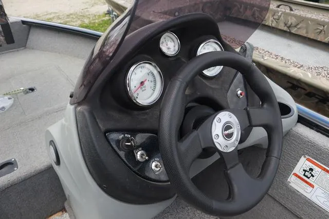 Slide: The Image of Steering console of 2013 Tracker Super Guide V-16 SC boat with gauges and controls. - 10