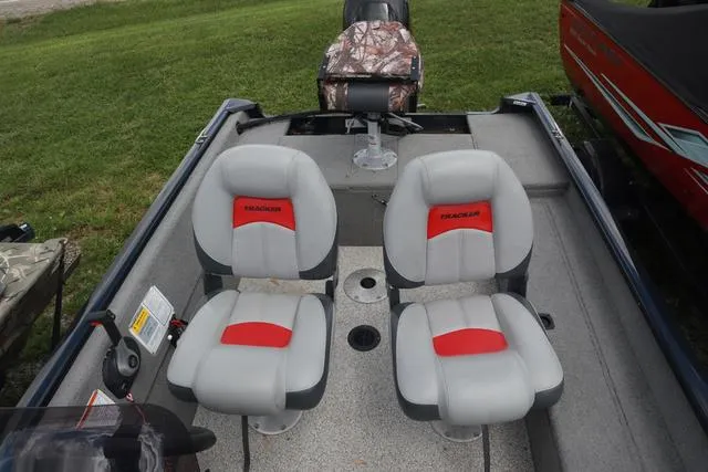 Slide: The Image of 2013 Tracker Super Guide V-16 SC boat interior with two gray and red seats. - 11