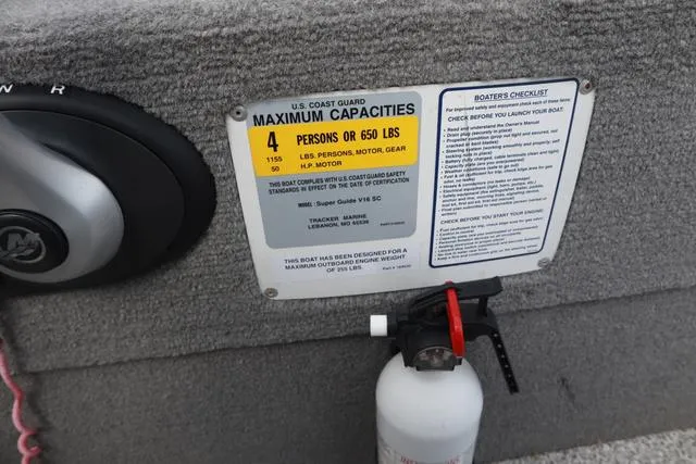 Slide: The Image of 2013 Tracker Super Guide V-16 SC capacity plate and fire extinguisher on boat interior. - 12