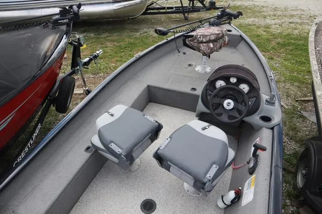 Slide: The Image of 2013 Tracker Super Guide V-16 SC boat interior with steering wheel and seating. - 5
