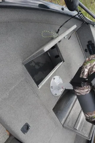 Slide: The Image of 2013 Tracker Super Guide V-16 SC boat interior with storage compartment and seat. - 8