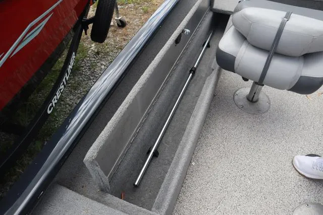 Slide: The Image of 2013 Tracker Super Guide V-16 SC boat interior with rod storage and seating. - 9