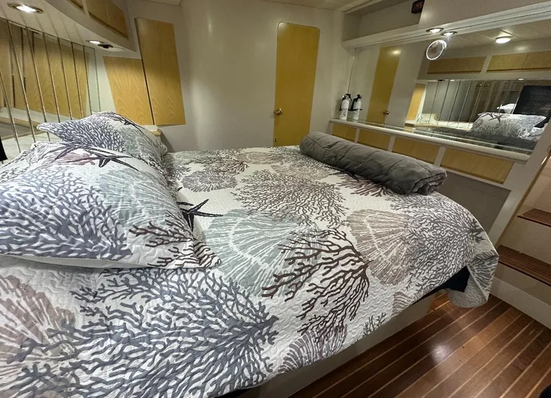 Slide: The Image of 1994 President 445 Sundeck yacht docked, featuring spacious deck and tender boat. - 10