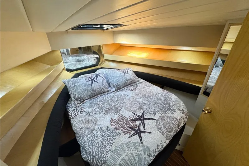 Slide: The Image of Cozy bedroom in 1994 President 445 Sundeck yacht with nautical-themed bedding. - 101
