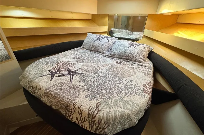 Slide: The Image of Cozy bedroom in 1994 President 445 Sundeck yacht with starfish-themed bedding. - 103