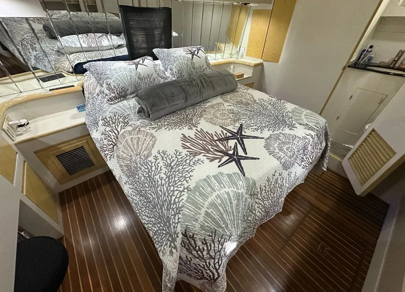 Slide: The Image of 1994 President 445 Sundeck yacht docked with small boat, chairs, and American flag. - 11