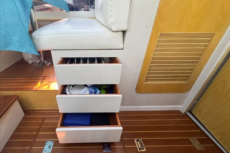 Slide: The Image of Interior of 1994 President 445 Sundeck with open storage drawers and seating. - 111