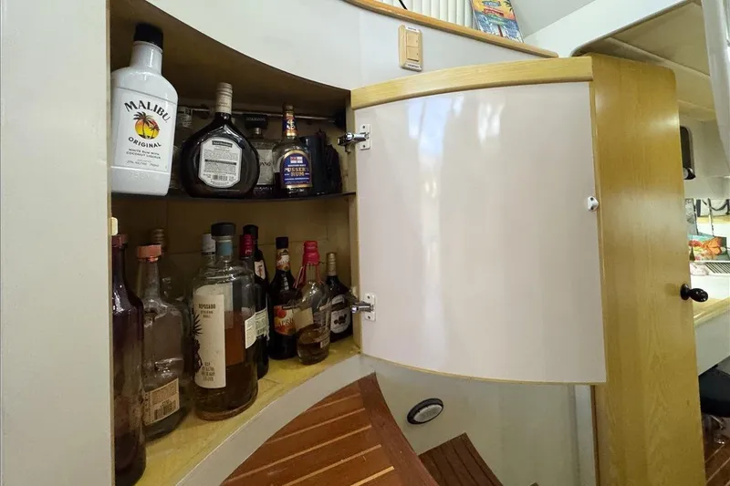 Slide: The Image of Cabinet with assorted liquor bottles on a 1994 President 445 Sundeck yacht. - 113