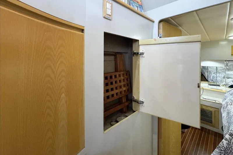 Slide: The Image of 1994 President 445 Sundeck interior with open storage compartment and wooden accents. - 114